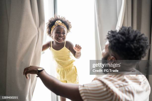 father and daughter playing hide and seek at home - pure joy stock pictures, royalty-free photos & images