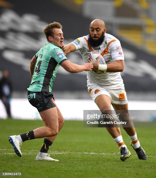 Sam Kasiano of Catalans hands off Jez Litten of Hull KR during the Betfred Super League match between Catalans Dragons and Hull Kingston Rovers at...