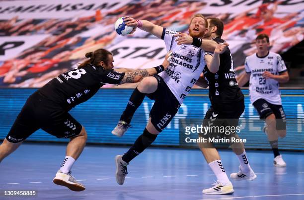 Jim Gottfridsson of SG Flensburg-Handewitt challenge Pavel Horak and Steffen Weinhold of THW Kiel during the Liqui Moly Handball Bundesliga match...