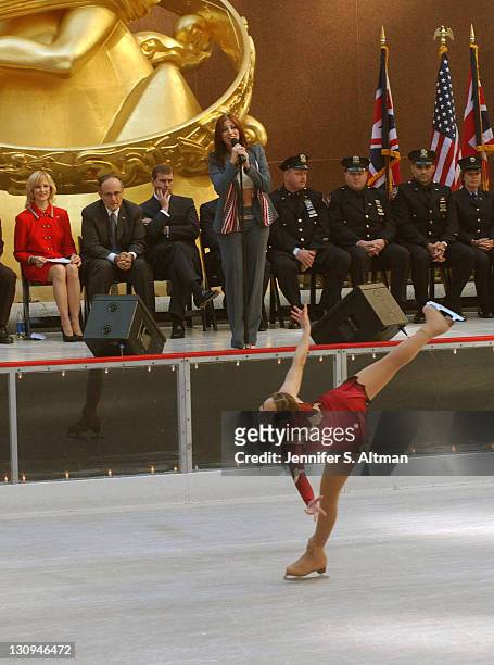Joanna Glick skates and Deborah Gibson sings "What Makes a Hero" as Mayor Giuliani, second from left, HRH Prince Andrew, third from left, and rescue...