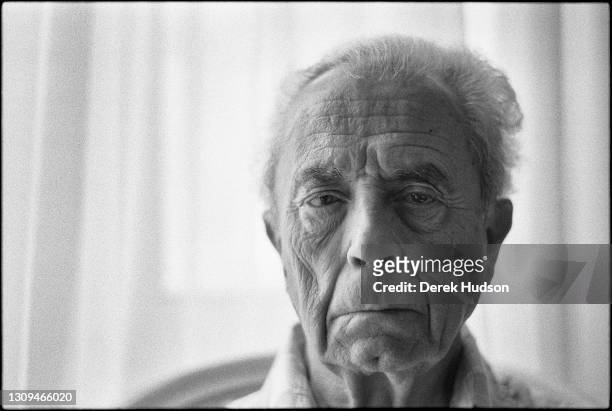 Italian director Michelangelo Antonioni sits for a portrait in the suite of his hotel, the Carlton, Cannes, which he attended as honorary guest in...