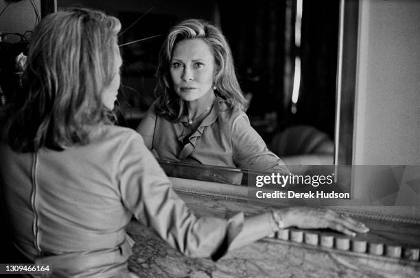 American actress Faye Dunaway pictured looking into a mirror during a portrait session in the Carlton Hotel, Cannes.