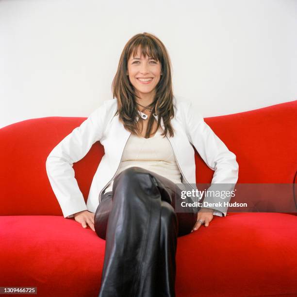 French actress Isabelle Yasmina Adjani poses for a photo session on a red sofa in Cannes.