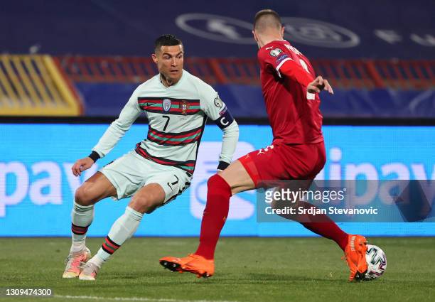 Cristiano Ronaldo of Portugal and Strahinja Pavlovic of Serbia battle for the ball during the FIFA World Cup 2022 Qatar qualifying match between...