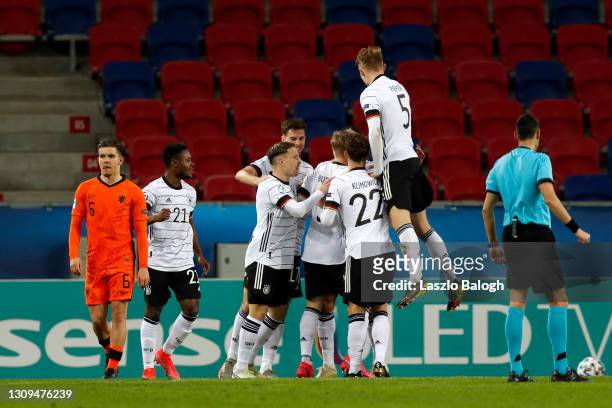 Lukas Nmecha of Germany celebrates with teammates after scoring their team's first goal during the 2021 UEFA European Under-21 Championship Group A...