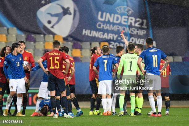 Oscar Mingueza of Spain is shown a red card and sent off by referee Harm Osmers during the 2021 UEFA European Under-21 Championship Group B match...