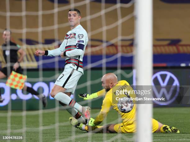 Cristiano Ronaldo of Portugal takes a shot under pressure from Marko Dmitrovic of Serbia during the FIFA World Cup 2022 Qatar qualifying match...