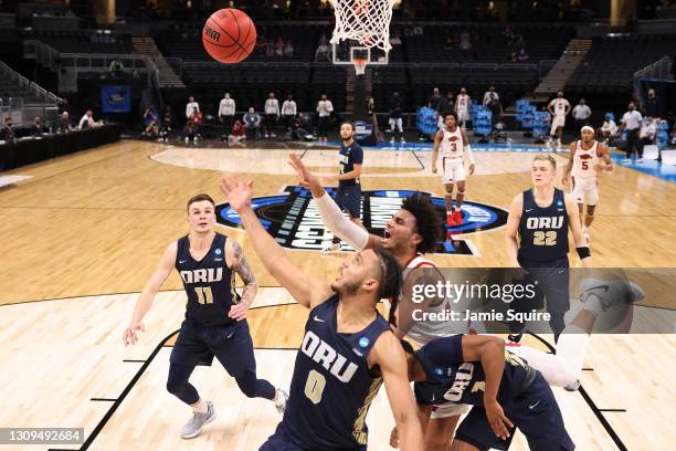 Justin Smith of the Arkansas Razorbacks and Kevin Obanor of the Oral Roberts Golden Eagles reach for a rebound during the first half in the Sweet...