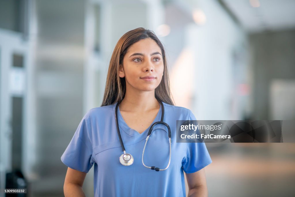 Confident medical student wearing medical scrubs