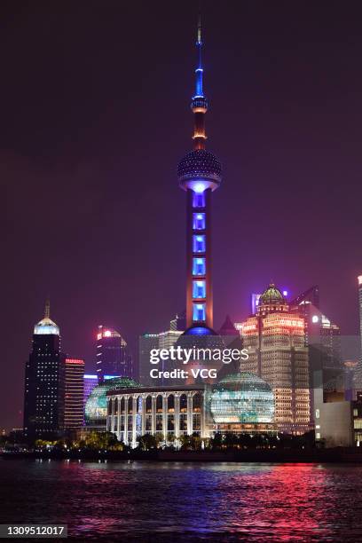 The Oriental Pearl Tower with the lights on is seen before Earth Hour 2021 on March 27, 2021 in Shanghai, China. Earth Hour 2021 is an environmental...