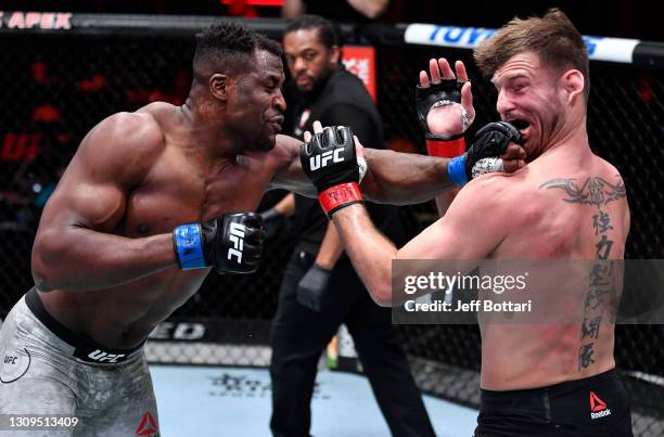 Francis Ngannou of Cameroon punches Stipe Miocic in their UFC heavyweight championship fight during the UFC 260 event at UFC APEX on March 27, 2021...