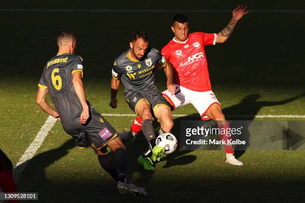 Ivan Franjic of Macarthur FC clears the ball to stop the shot of Jaushua Sotirio of the Phoenix during the A-League match between Wellington Phoenix...