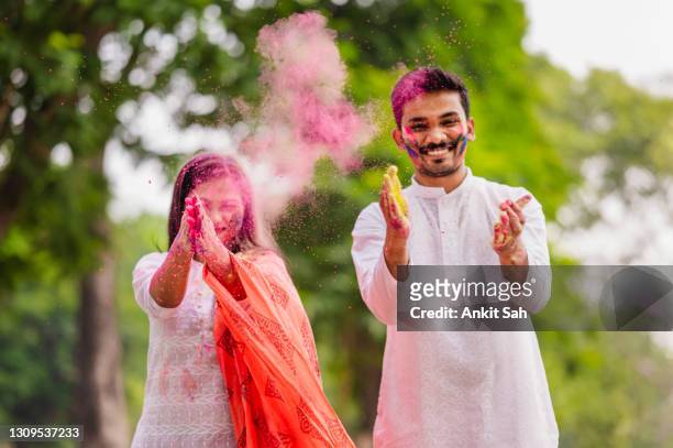 happy fun loving couple painted in powder colors or gulal and celebrating holi festival - ethnicity stock pictures, royalty-free photos & images