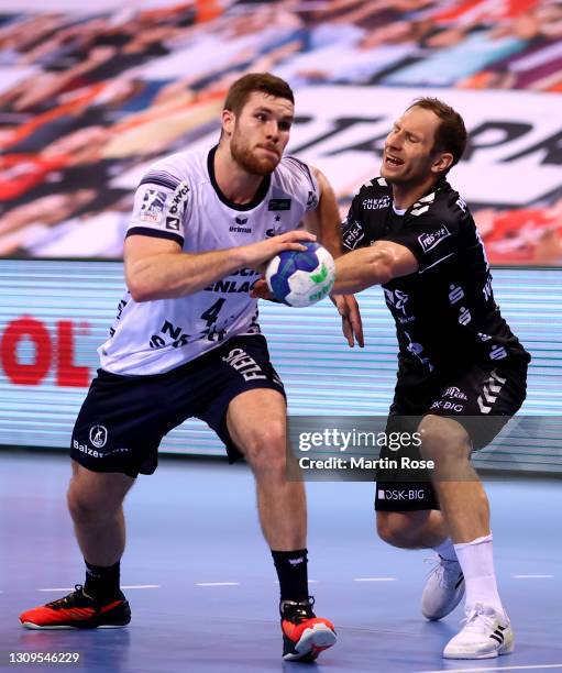 Johannes Golla of SG Flensburg-Handewitt challenges Steffen Weinhold of THW Kiel during the Liqui Moly Handball Bundesliga match between SG...