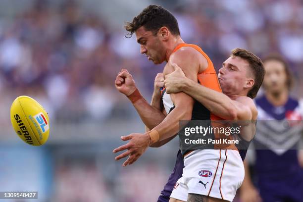 Tim Taranto of the Giants gets tackled by Caleb Serong of the Dockers during the round 2 AFL match between the Fremantle Dockers and the GWS Giants...