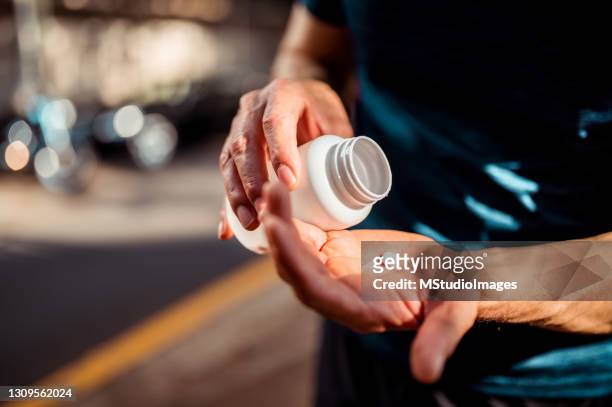 close up of human hands. he is taking pill - diabetes pills stock pictures, royalty-free photos & images