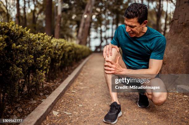 the athlete has knee pain - pain stock pictures, royalty-free photos & images