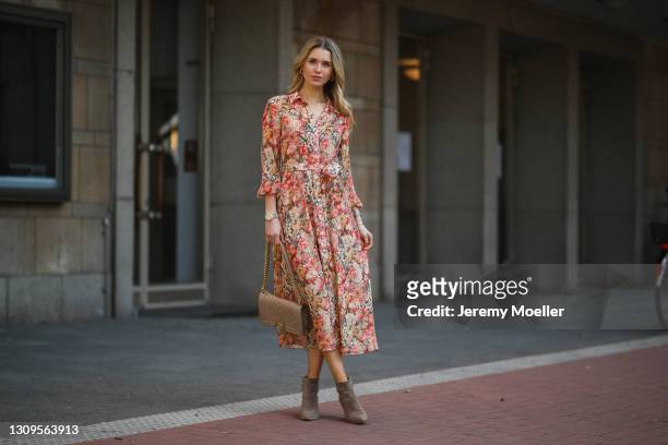 Scarlett Gartmann wearing Mango flower dress, beige Chanel Boy bag and brown Kennel & Schmenger leather boots on March 24, 2021 in Dusseldorf,...