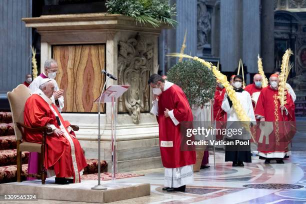 Pope Francis, flanked by cardinals and bishops, attends the Palm Sunday Mass at Vatican Basilica of St. Peter's on March 28, 2021 in Vatican City,...