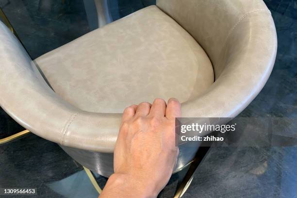 human hand holding the back of the chair - back of chair stock pictures, royalty-free photos & images