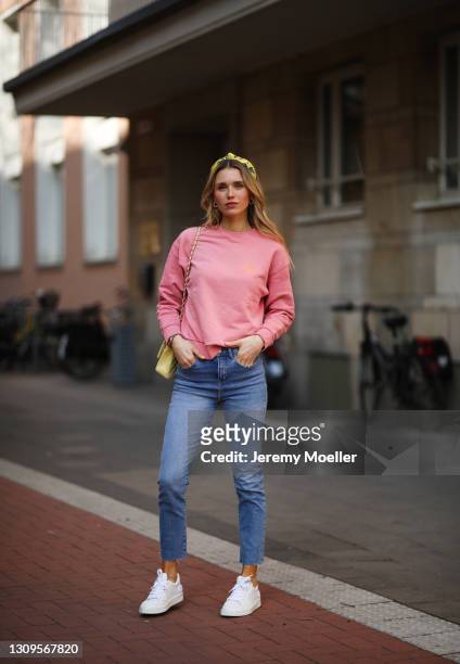 Scarlett Gartmann wearing pink Vogue sweater, Zara blue jeans, yellow H&M headband, yellow Chanel leather bag and white Chanel sneakers on March 24,...