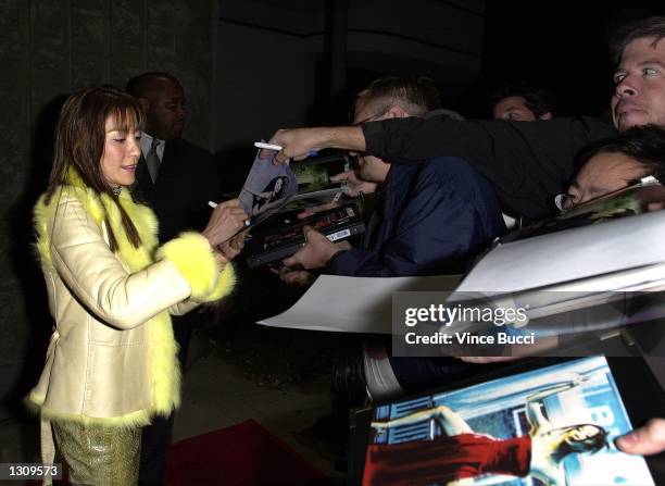 Cast member Michelle Yeoh signs autographs for fans as she arrives at the premiere of "Crouching Tiger, Hidden Dragon" December 5, 2000 in Beverly...