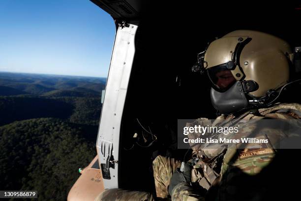 Member of the 5th Aviation Regiment, Townsville is seen aboard a MRH-90 Taipan heading toward Taree from Richmond RAAF Base on March 28, 2021 in...