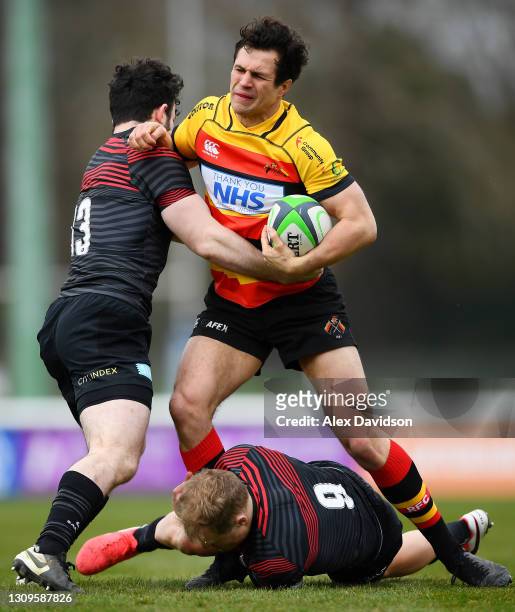 Cameron Mitchell of Richmond is tackled by Aled Davies and Dom Morris of Saracens during the Greene King IPA Championship match between Richmond and...