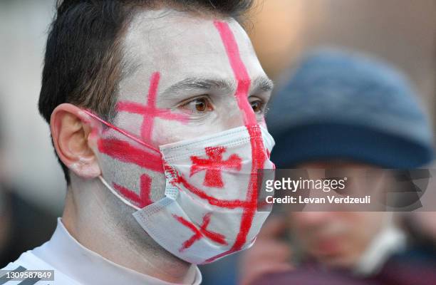 Georgia fan wearing face paint and a face mask looks on outside the stadium prior to the FIFA World Cup 2022 Qatar qualifying match between Georgia...