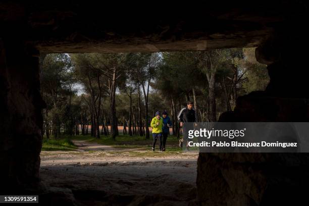 Men running are seen through the hole of a machine gun pillbox that was used by Republicans to defend Madrid from Franco's forces during the Spanish...