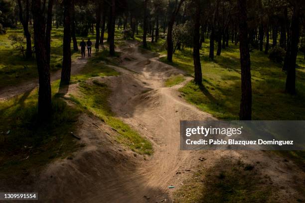 People run next to a communication trench that was used by Republicans to defend Madrid from Franco's forces during the Spanish Civil War following...