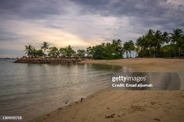 artificial siloso beach, sentosa island, singapore - sentosa island stock-fotos und bilder