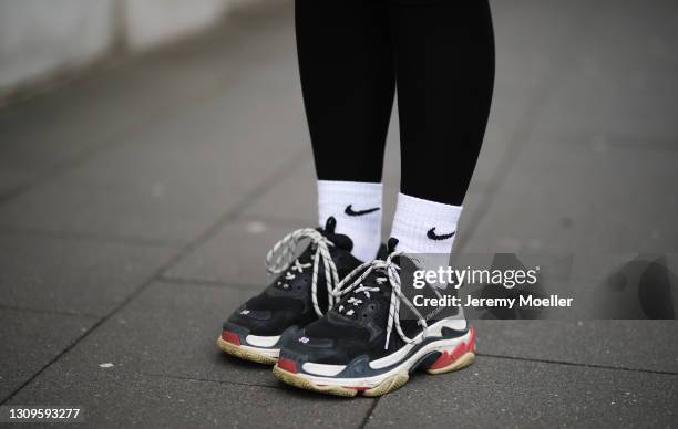 Franzi König wearing black Les Lunes leggings, white Nike socks and Balenciaga triple S sneakers on March 27, 2021 in Cologne, Germany.