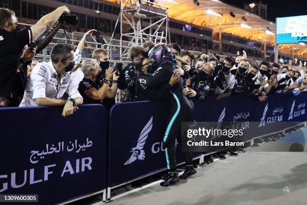 Race winner Lewis Hamilton of Great Britain and Mercedes GP celebrates with team members in parc ferme during the F1 Grand Prix of Bahrain at Bahrain...