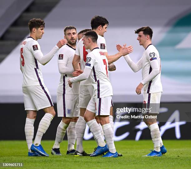 Mason Mount of England celebrates with team mates John Stones, Luke Shaw, Harry Maguire and Phil Foden after scoring their side's second goal during...