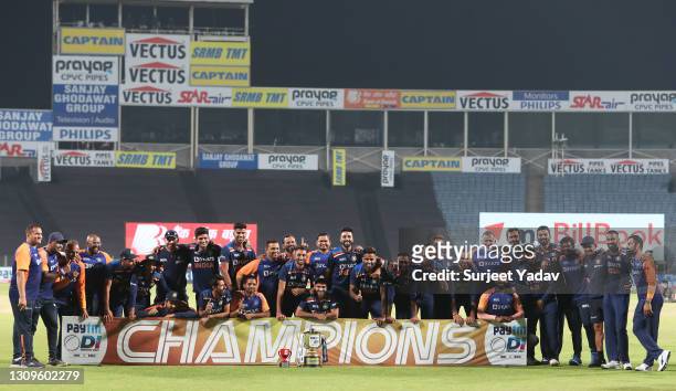 Players and Staff of India pose with the trophy after winning the ODI series during the 3rd One Day International match between India and England at...