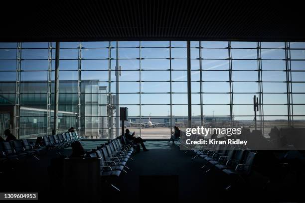 Passengers wait for their flights at Paris Charles de Gaulle Airport, as the French Government clamps down on national and international travel in a...