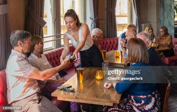 contactless payment for drinks by phone - leeds england stock pictures, royalty-free photos & images