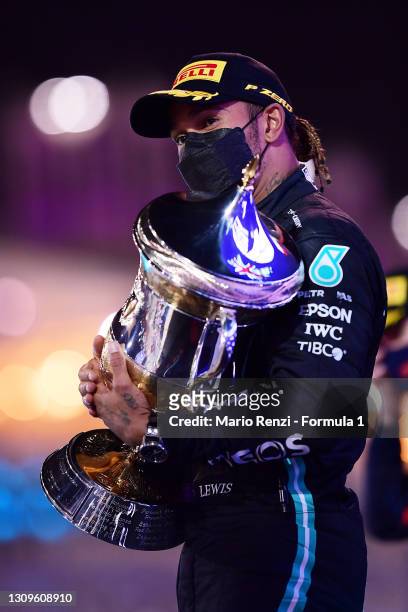 Race winner Lewis Hamilton of Great Britain and Mercedes GP celebrates on the podium after the F1 Grand Prix of Bahrain at Bahrain International...