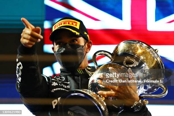 Race winner Lewis Hamilton of Great Britain and Mercedes GP celebrates on the podium after during the F1 Grand Prix of Bahrain at Bahrain...