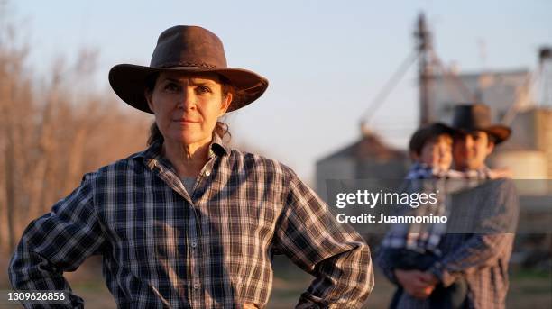 mature woman posing with her son and grandson in rural countryside - rancher stock pictures, royalty-free photos & images