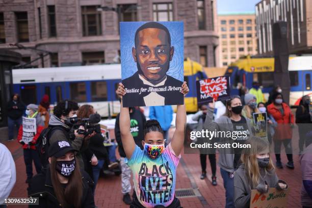 People gather outside of the Hennepin County Government Center for a rally being held before the start of trial of former Minneapolis police officer...