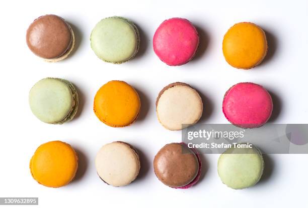 macaroon colorful desserts on white background isolated flat lay - food coloring stock pictures, royalty-free photos & images