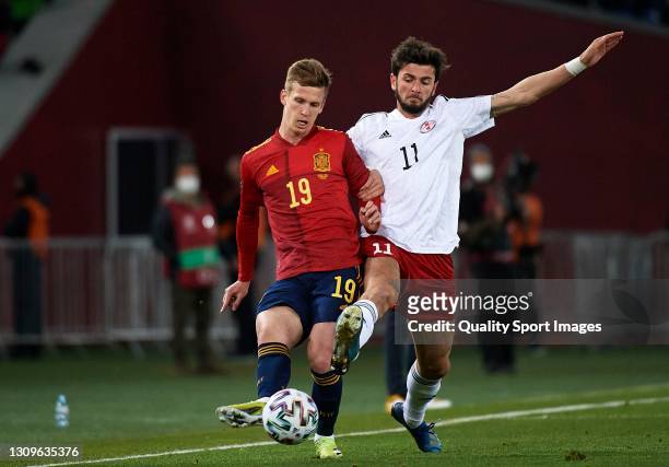 Giorgi Kvilitaia of Georgia competes for the ball with Daniel Olmo of Spain during the FIFA World Cup 2022 Qatar qualifying match between Georgia and...