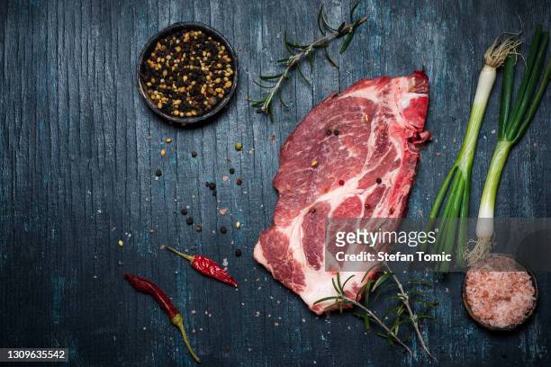 fresh pork meat on rustic wooden table - pork cuts stock pictures, royalty-free photos & images