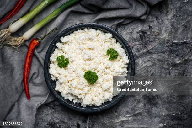 crumbled young cow cheese in a bowl - feta cheese imagens e fotografias de stock