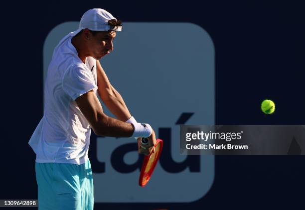 Alexei Popyrin of Australia returns a shot during his men's singles third round match against Daniil Medvedev of Russia on Day 7 of the 2021 Miami...