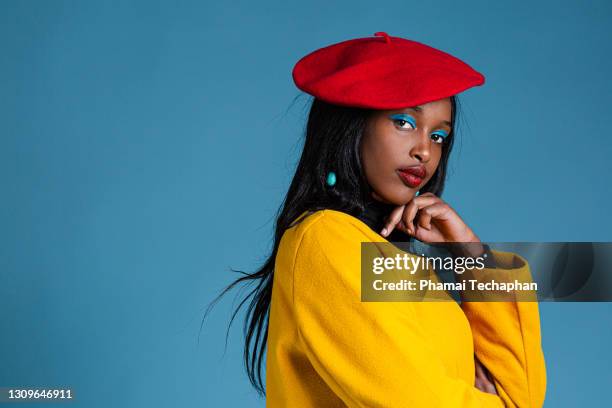 fashionable woman wearing yellow coat - beret cap stock pictures, royalty-free photos & images