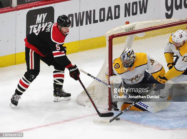 Connor Murphy of the Chicago Blackhawks gets off a shot against Pekka Rinne of the Nashville Predators at the United Center on March 28, 2021 in...