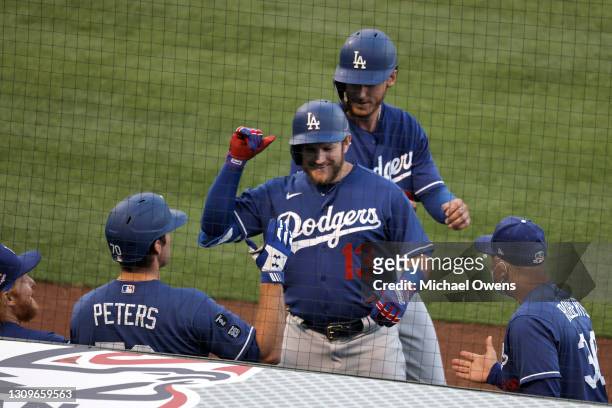 Max Muncy of the Los Angeles Dodgers celebrates his two-run home run with teammates against the Los Angeles Angels during the second inning of a MLB...